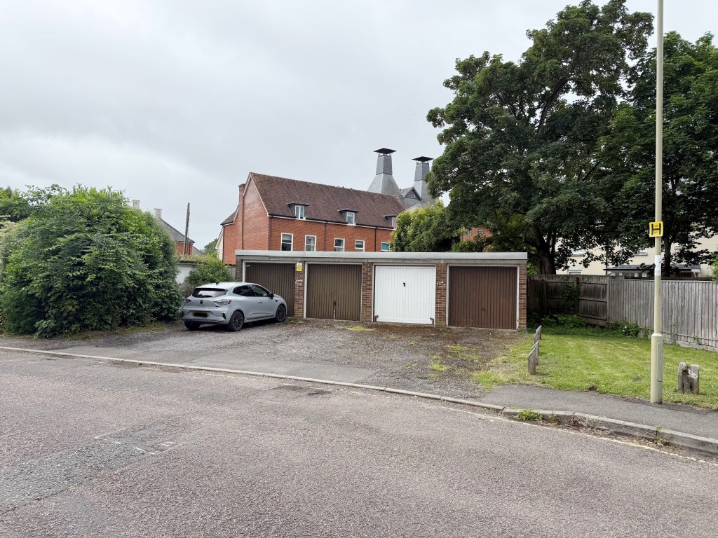 Lot: 9 - THREE LOCK-UP GARAGES IN ATTRACTIVE MARKET TOWN - View of the garages from the road